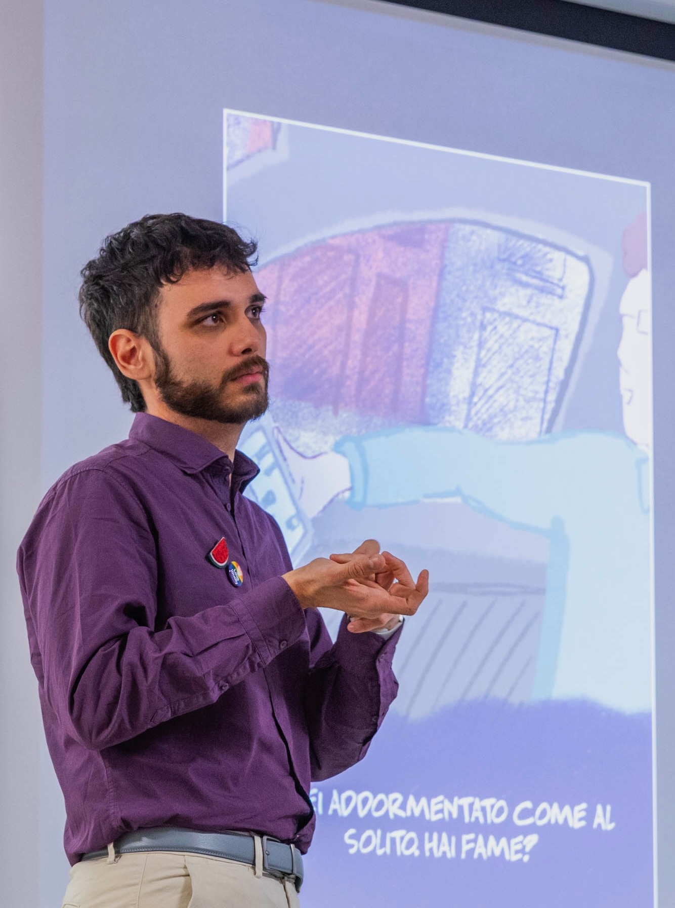 Simone presenting in front of a projected illustration.